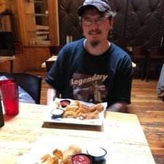 Catfish Guy Peter Robinson eating a catfish dish named after him at Baked.