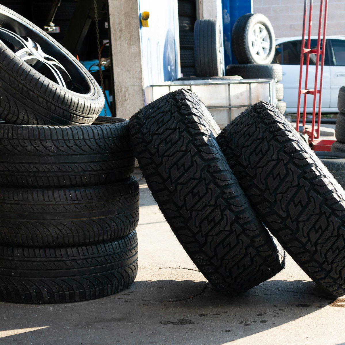 Stack of tires outside a garage