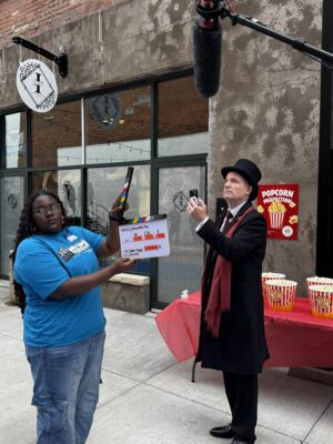 A Fresh Films student works with actor Marc Evan Jackson (who plays the mayor in Groundhog Gary," last summer in Rock Island's Arts Alley.