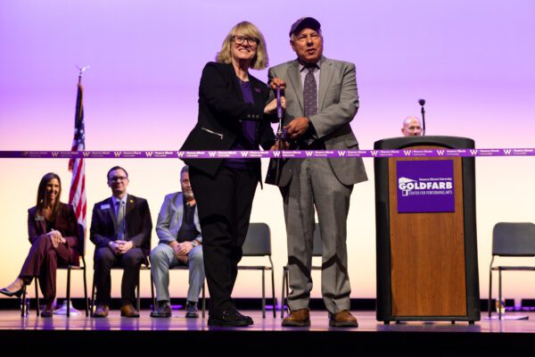 WIU President Kristi Mindrup and President Emeritus Alvin Goldfarb cut the ribbon on the new Goldfarb Center for Performing Arts.
