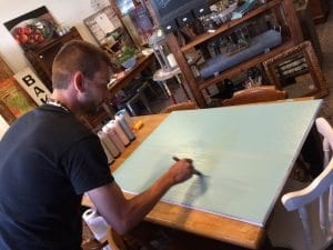 Christopher Anderson works on a painting he will be donating to MCSA as part of its renovation. Anderson’s first book, “Boots,” a children’s tome about MCSA, is available at the shelter. (Sean Leary photo)