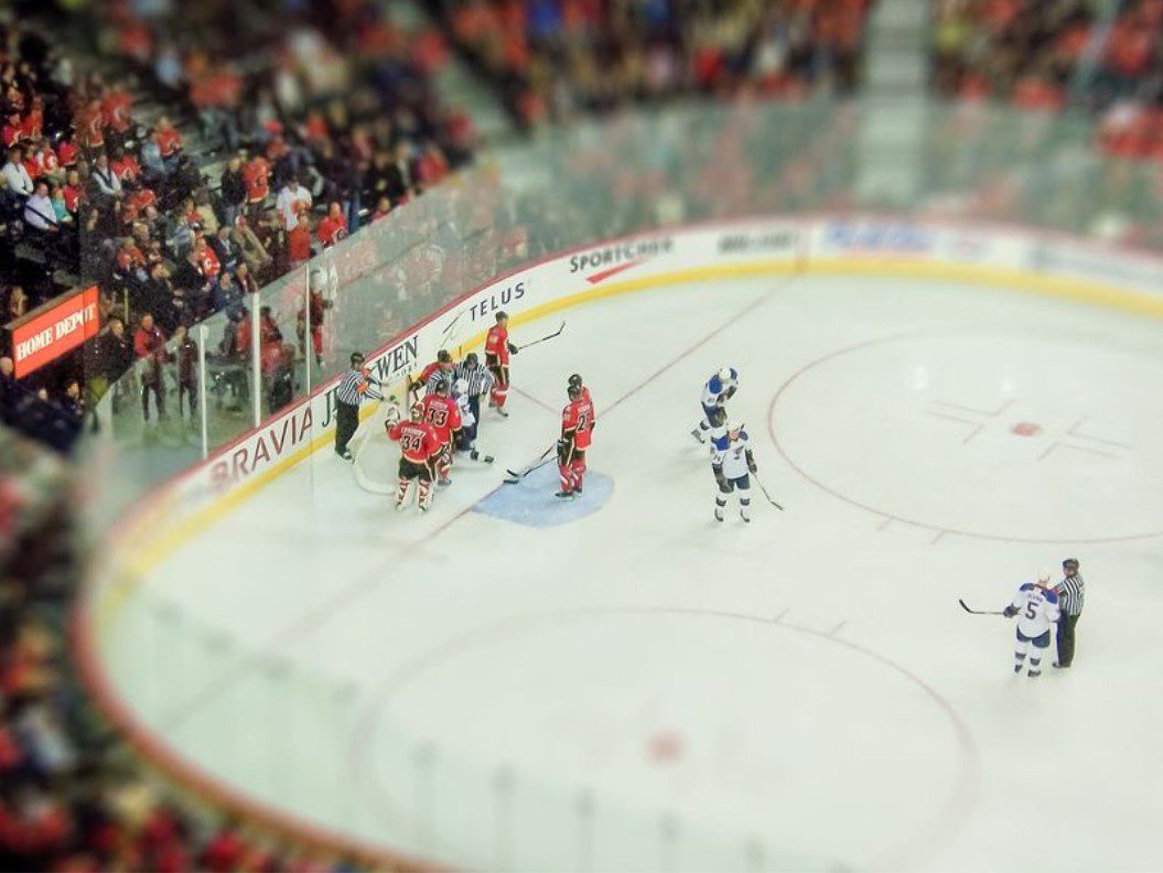 Hockey players gather near the goal - QuadCities.com