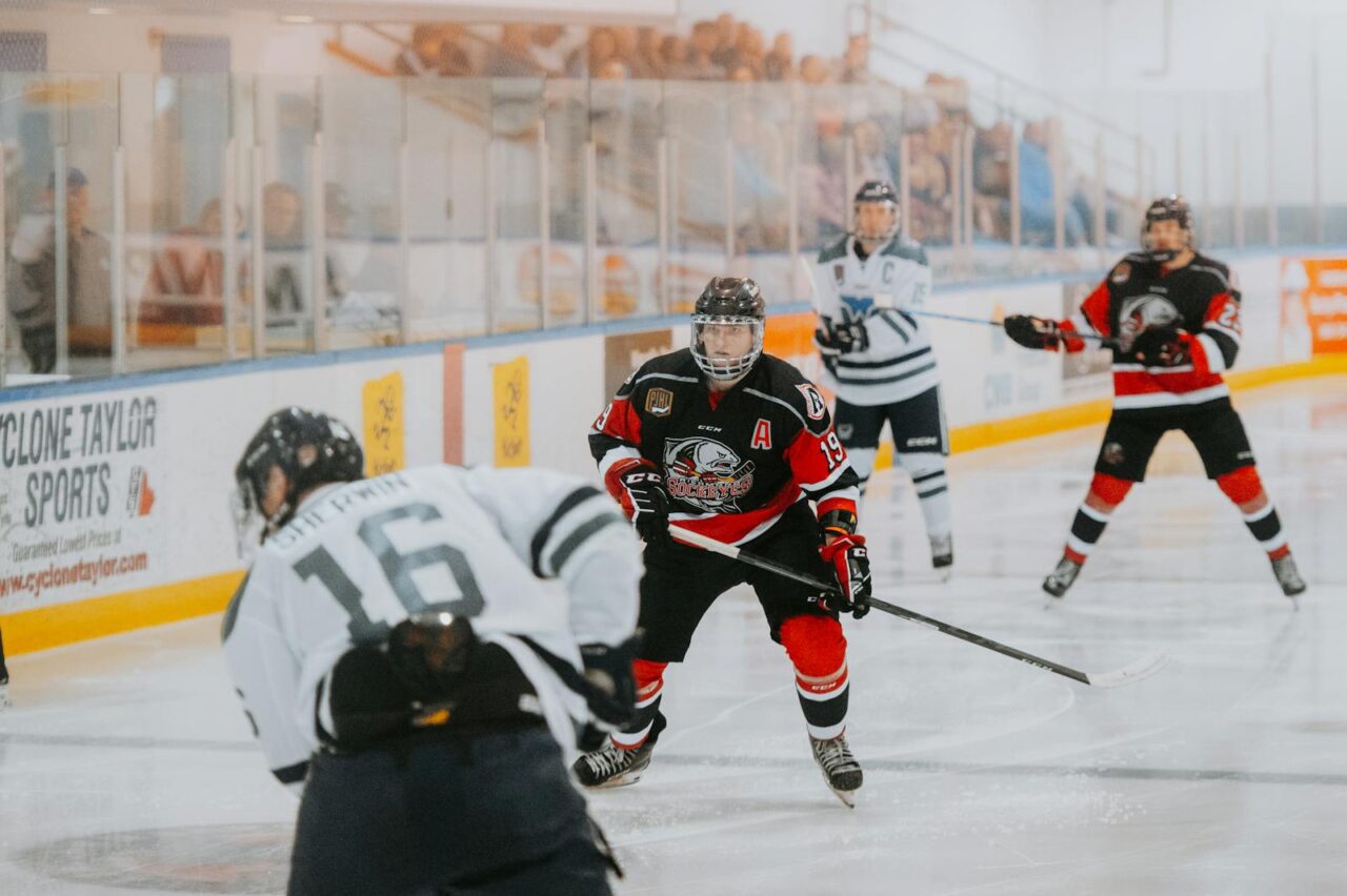 Quad Cities Local Sports Highlights Intense ice hockey match with players competing fiercely on the rink.