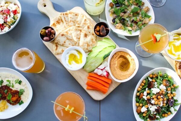 A table topped with plates of food and drinks