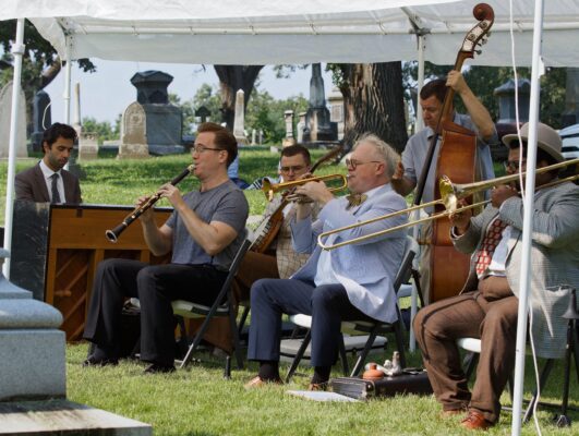Musicians performed at the Bix gravesite at Davenport's Oakdale Memorial Gardens, as part of the Bix jazz festival. (credit: Common Chord)