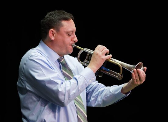 Trumpeter Andy Schumm, a Bix expert, performing during a Bix jazz festival. (credit: Common Chord)