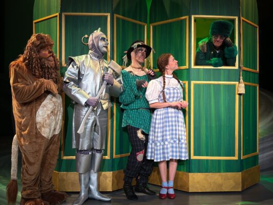 Jeremy Littlejohn (left), as Lion, Bobby Becher as Tin Man, Adam Cerny as Scarecrow and Sophie Kaegi as Dorothy greet Brad Hauskins as the Emerald City Guard in "The Wizard of Oz."