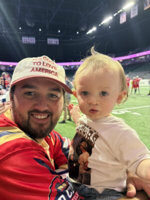 Colin Gould and his son Carver (who wore the "32 Beers" T-shirt) at the Steamwheelers game on July 25, 2026.